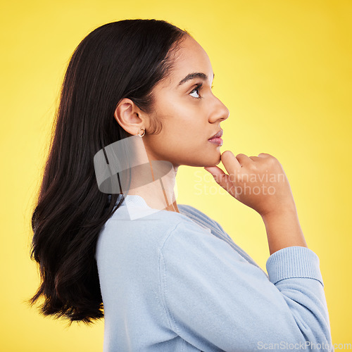 Image of Woman, profile and studio with a young model thinking with casual fashion feeling relax. Isolated, yellow background and gen z female person with youth and healthy hair care posing and relaxing