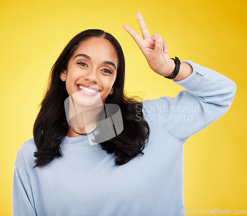 Image of Happy, woman and portrait of peace fingers in studio, background and color backdrop. Female model, v sign and smile with hands for victory, fun mood and happiness of gen z, victory and freedom emoji