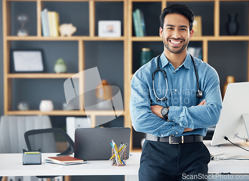 Image of Portrait, Asian man and doctor with arms crossed, healthcare and confident in workplace. Face, Japanese male employee and happy medical professional with leadership, skills and management in office