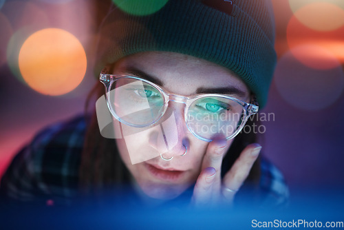 Image of Coding, face and serious woman working overtime at night programming a computer, website or app development. Focus. workaholic and young female student or web design freelancer with a deadline