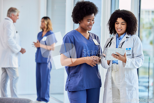 Image of Tablet, healthcare or collaboration with a doctor and nurse talking in the hospital while doing research. Medical, teamwork and trust with professional colleagues in medicine working in a clinic