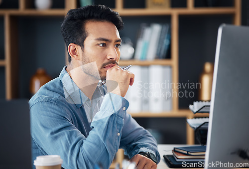 Image of Serious, business man and thinking on computer at desk, internet research and analysis. Focused male employee, desktop and solution of ideas, planning decision and review strategy, mindset and vision