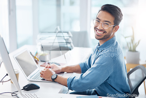 Image of Happy business man, portrait and laptop in office for happiness, startup management and planning. Young male worker, smile and computer technology with motivation, online project and pride at desk