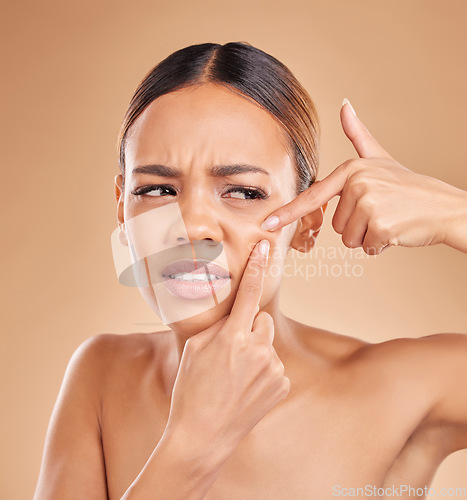 Image of Woman pop pimple on face, acne and dermatology, skincare and facial breakout on studio background. Beauty, cosmetic care and female hands, skin outbreak and cosmetics treatment for blackheads