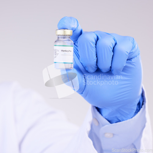 Image of Vaccine, doctor hands and monkeypox bottle for safety, medicine and healthcare innovation in studio. Closeup vaccination, person and liquid vial for drugs, medical virus and pharmaceutical research