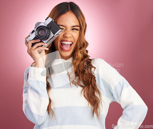 Image of Camera, photography and happy woman in studio for fun, posing and gen z retro aesthetic on pink background. Lens, photographer and girl posing for picture, photo or photograph on isolated mockup