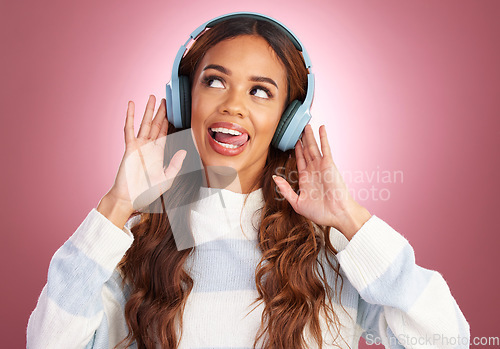 Image of Mockup, tongue out and woman with headphones, streaming music and happy against a pink studio background. Headset, female and lady with joy, silly and listening to radio with audio, song and sounds