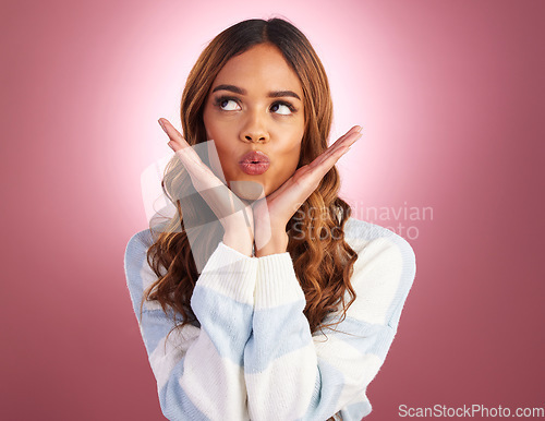 Image of Kiss, face and woman in a studio with funny, silly and emoji expression with a purple background. Female model, youth and happiness of a young and happy person kissing with a pout and casual fashion