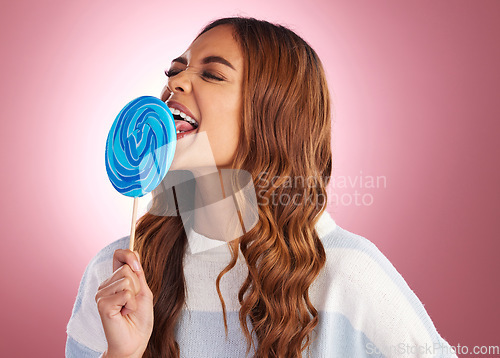 Image of Candy, lollipop and woman in studio with sugar snack, happy and having fun against a pink background. Sweet, satisfaction and colombian girl eating dessert, silly and posing while isolated on mockup