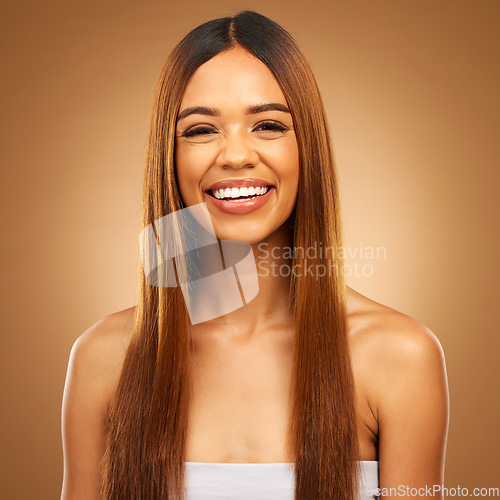 Image of Haircare, beauty and portrait of woman in studio for growth and color shine or healthy texture. Aesthetic female happy smile for hair, natural self care and hairdresser or salon on brown background