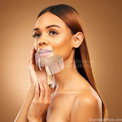 Image of Woman with hand on face, skin and haircare with bronze glow and luxury salon treatment on brown background. Beauty, makeup and skincare cosmetics, hispanic model with straight hair style in studio.