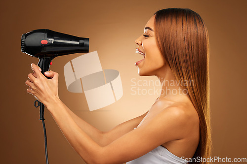 Image of Beauty, styling and hairdryer with woman in studio for hair care, shampoo and grooming. Salon treatment, glow and self care with model isolated on brown background for results, keratin and cosmetics