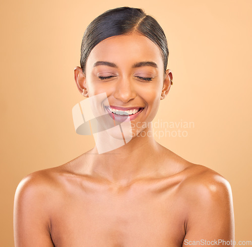 Image of Beauty, face and smile of woman in studio for skincare, cosmetics, dermatology or makeup. Aesthetic female .laughing for self care, natural skin and spa facial shine results on a brown background