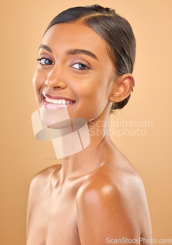 Image of Smile, beauty and portrait skincare of a woman isolated on a studio background. Happy, beautiful and an Indian model with a glow from cosmetics, healthy skin and smooth complexion on a backdrop