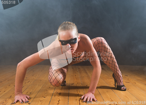 Image of Blond masked girl posing in smoke filled surroundings