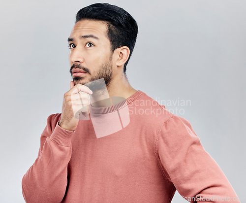 Image of Confusion, ideas and Asian man thinking, opportunity and decision against a grey studio background. Japan, male and guy with wonder, thoughts and contemplation with doubt, unsure and uncertainty