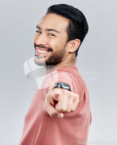 Image of Pointing, happy and smile with portrait of man in studio for thank you, motivation and amazing. Winner, confident and friendly with male on white background for yes, achievement and satisfaction