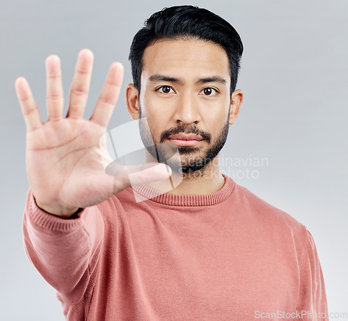 Image of Portrait, five and hand for stop, Asian man and warning with serious expression against a grey studio background. Face, Japanese male and guy with gesture for halt, raising palm and showing number