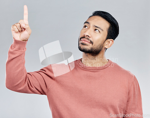 Image of Promo, announcement and Indian man pointing up with mockup and product placement isolated on white background. Promotion, information and notification space, person in studio with launch idea or info