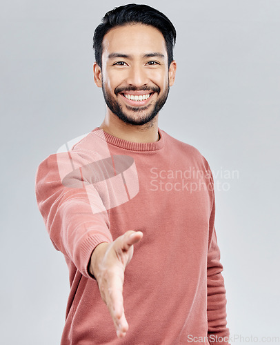 Image of Asian man, portrait smile and handshake for meeting, deal or introduction isolated against white studio background. Happy male smiling and shaking hands for greeting, introduction or friendly gesture