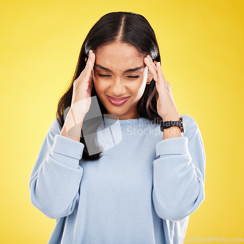 Image of Young woman, stress and burnout with headache, pain and distress isolated on yellow studio background. Female massage temple, mental health and anxiety with depression, frustrated and trauma migraine