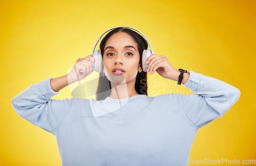 Image of Music, headphones and portrait of woman in studio for streaming, online radio and audio. Relax, media and podcast with female isolated on yellow background for technology, listening and connection