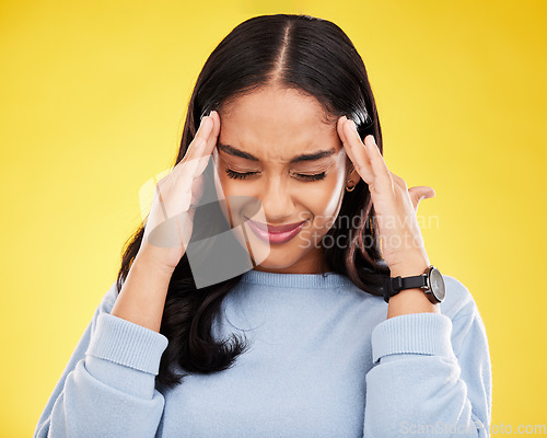 Image of Young woman, stress and headache with pain and distress, frustrated and agony on yellow studio background. Female massage temple, mental health and anxiety with depression, migraine and trauma