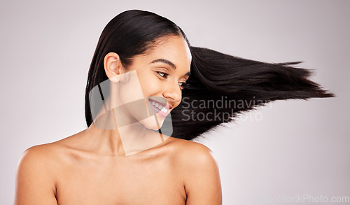 Image of Beauty, hairstyle and wind with woman in studio for shampoo, confidence and keratin treatment. Textures, salon and shine with female model on white background for glow, self care and cosmetics