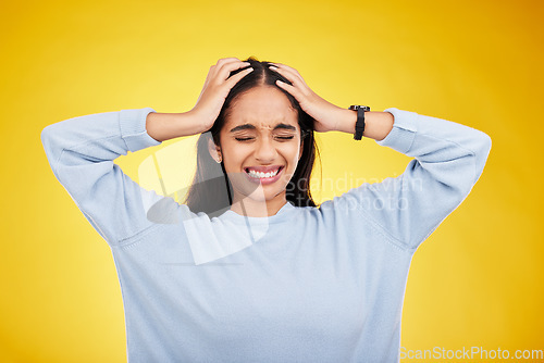 Image of Young woman, stress and frustrated with headache, pain and distress isolated on yellow studio background. Female holding head, mental health and anxiety with depression, migraine and trauma