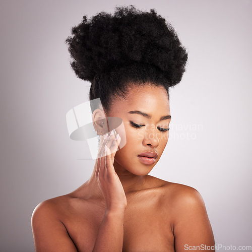 Image of Skincare, beauty and black woman with hand on face, white background and cosmetics. Health, dermatology and natural makeup and African model in studio space for healthy skin care and wellness.