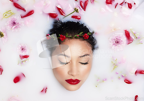 Image of Beauty, milk and flowers with woman in bath for spa treatment, relax and skincare. Wellness, cosmetics and pampering with female and rose petals from top view for grooming, satisfaction and self care