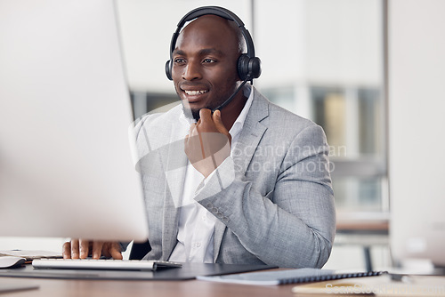 Image of Black man, call center and computer with headset for telemarketing, customer service or support at office desk. Happy African American male consultant agent smiling with headphones on PC for advice