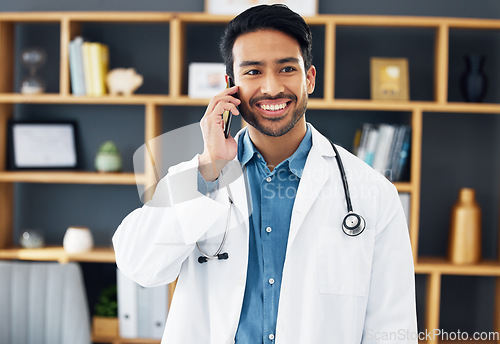 Image of Asian man, doctor and phone call with smile for healthcare consulting, conversation or chat at hospital. Happy male medical expert smiling on mobile smartphone in communication or health consultation