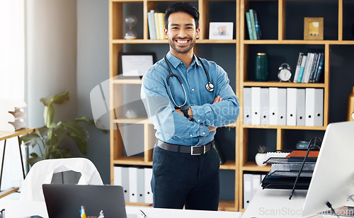 Image of Portrait, man and doctor with arms crossed, hospital and confidence with smile, proud of career and employee. Face, medical professional and male consultant with medicine, wellness and development