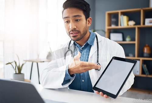 Image of Mockup, consultation and a doctor on a video call with a tablet for results, healthcare support and advice. Talking, consulting and an Asian gp with a blank screen tech for a telehealth webinar