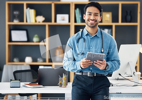 Image of Smile, tablet and portrait of doctor in office using the internet or web for medical search online, confident and satisfied. Man healthcare professional or GP holding digital device for communication