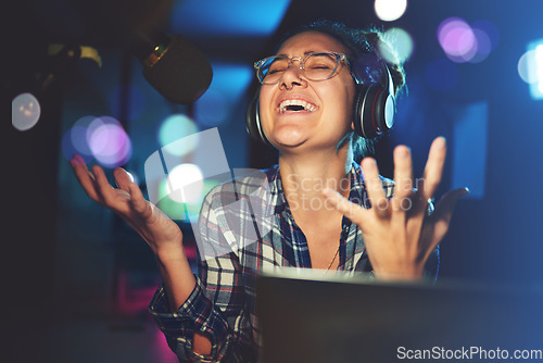 Image of Radio DJ, headphone and microphone, woman is excited with singing or talking, broadcast media and announcement. Female in studio booth, recording and happiness with smile, excitement and carefree