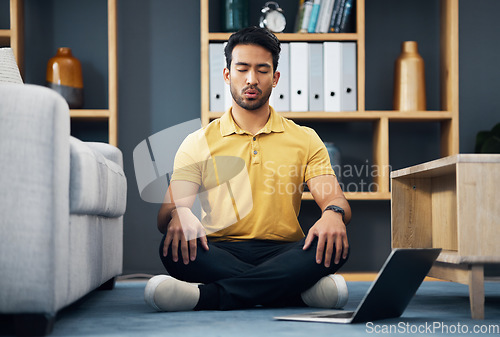 Image of Meditation, laptop and a yoga man breathing for mental health, wellness or zen on the floor of his home. Fitness, internet and virtual class with a male yogi in the living room to meditate for peace