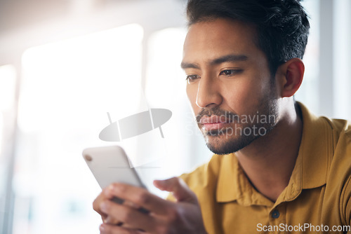 Image of Serious asian man, phone and social media for communication or networking at home. Focused male freelancer face on mobile smartphone app for chatting, texting or browsing on internet or research