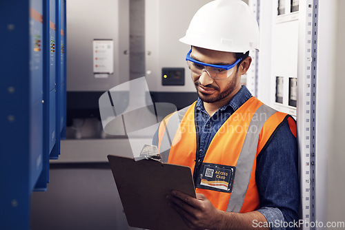 Image of Man, electricity and technician in control room, writing notes and machine maintenance on clipboard. Male electrician, system and electrical substation for power, engineering inspection and checklist