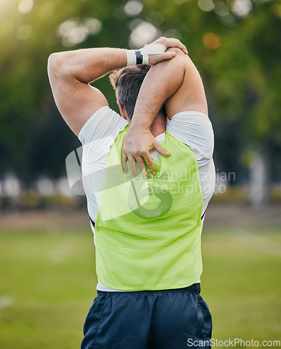 Image of Back, fitness and man stretching, training and outdoor for workout, exercise and sports for wellness. Male athlete, guy and player stretch arms, soccer and practice for competition, match and health