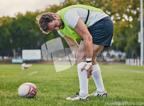 Image of Rugby, pain and man with legs injury on sports field after practice match, training and game outdoors. Medical emergency, accident and male athlete with joint inflammation, knee sprain and tendinitis