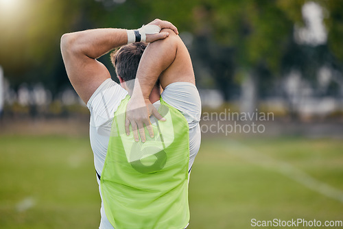 Image of Back, stretching and man training, fitness and exercise for balance, wellness and healthy lifestyle on field. Male athlete, guy and player outdoor, stretch and fitness for practice, workout or sports