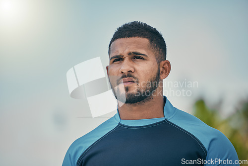 Image of Sport, sky and man with serious expression, confidence and pride in winning game with focus. Fitness, sports and dedication, rugby player at match, workout or competition at stadium in New Zealand.