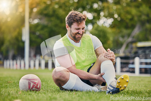 Image of Football, man and knee pain on grass field, inflammation and bruise with training, workout and exercise. Male player, athlete or guy on ground, leg injury and health issue with practice and emergency