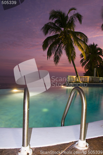 Image of luxury infinity swimming pool caribbean sunset