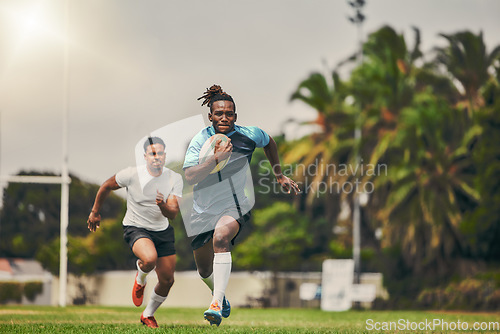 Image of Rugby, chase and black man with ball running to score goal on field at game, match or practice workout. Sports, fitness and motion, player in action and blur on grass with energy and skill in sport.