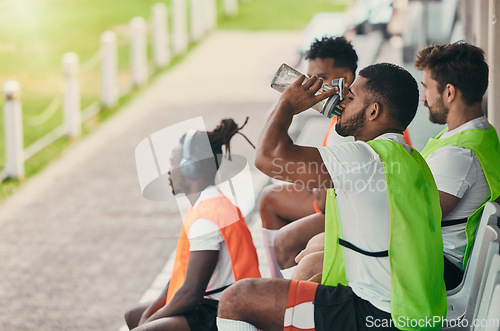 Image of Team, rugby men and fitness on bench with drinking water, relax or sitting with diversity, solidarity or health. Group teamwork, university or professional sports at stadium for game, friends or goal