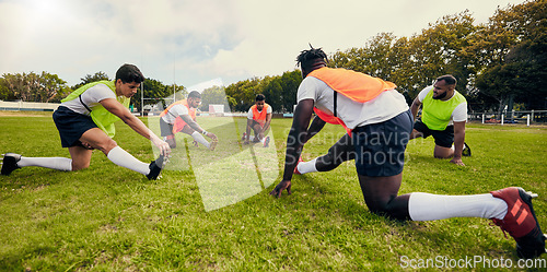 Image of Sports, training and men outdoor for rugby on grass field with diversity team stretching as warm up. Athlete group together for fitness, exercise and workout for professional sport or teamwork energy