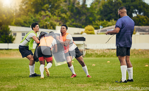 Image of Rugby, teamwork and men training on field with equipment ready for match, practice and sport games. Fitness, competition and male athletes tackle bag for warm up, exercise and workout with coach